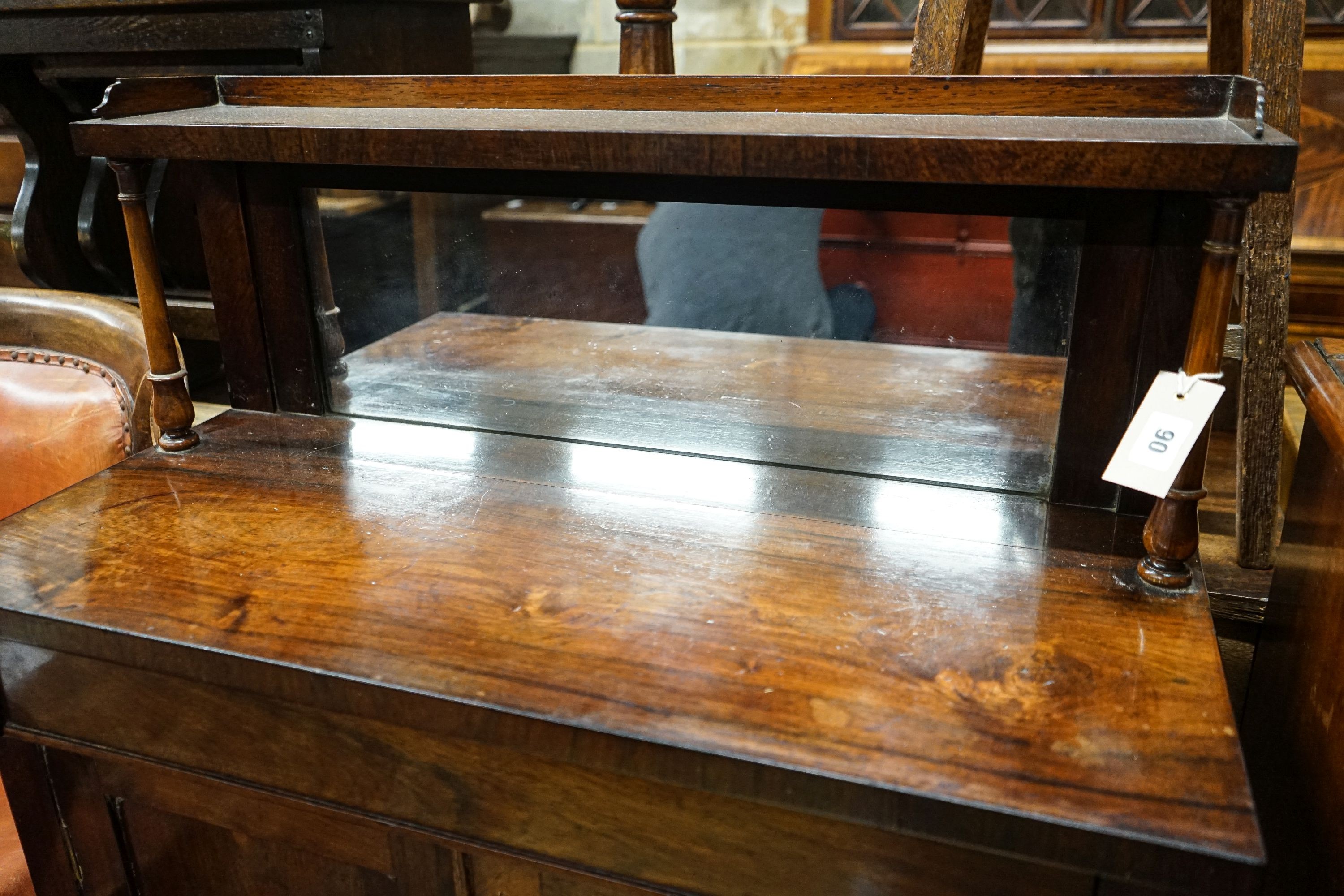 A small Victorian rosewood chiffonier with raised mirror back, 3/4 gallery over a pair of plain panelled doors on plinth base, width 77cm, depth 34cm, height 112cm